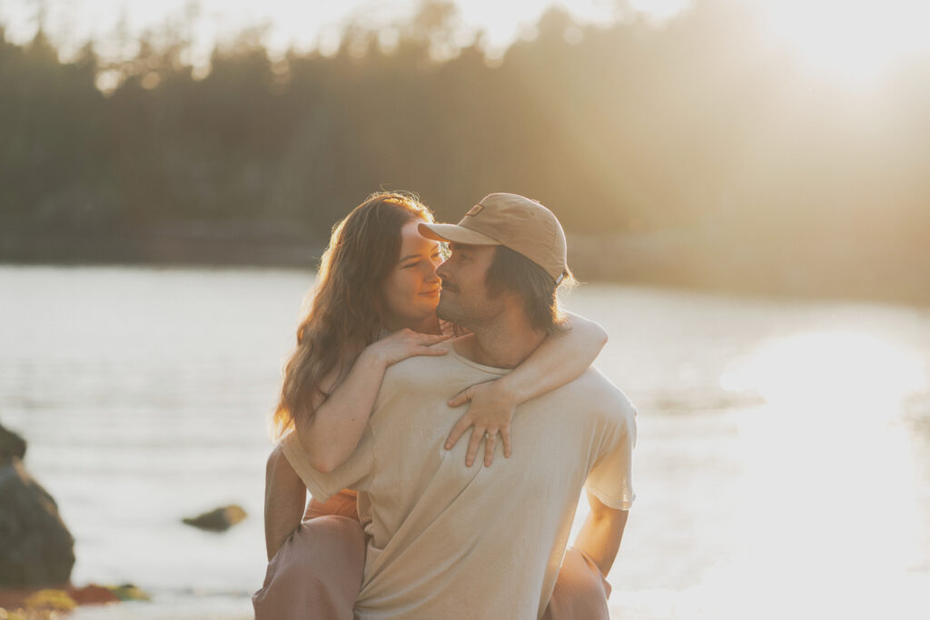 couple sharing an intimate moment on a beach in ucluelet