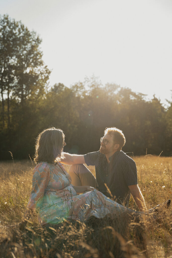 Expecting parents in a field of tall grasses in Comox by Latitude 49 photography