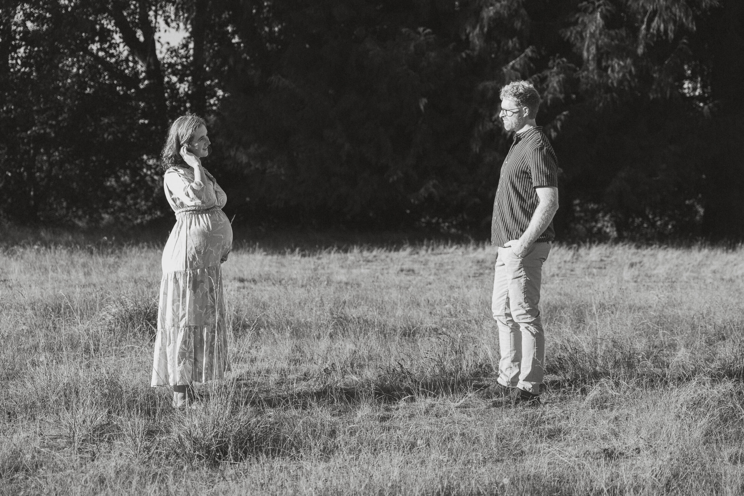 Expecting parents in a field of tall grasses in Comox by Latitude 49 photography