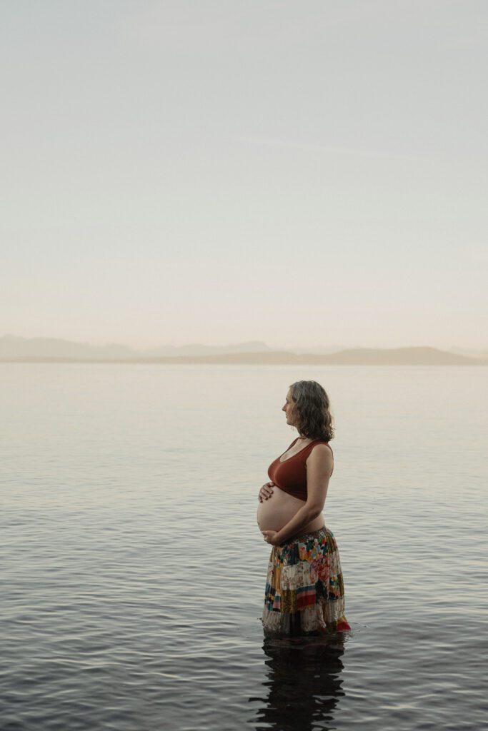 Expecting mother on the beach in Comox by Latitude 49 photography