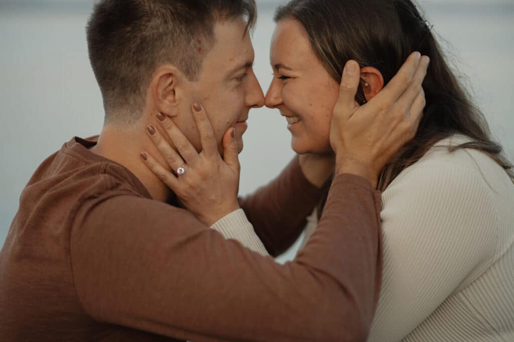 Couple at Airforce beach during their engagement session by latitude 49 photography