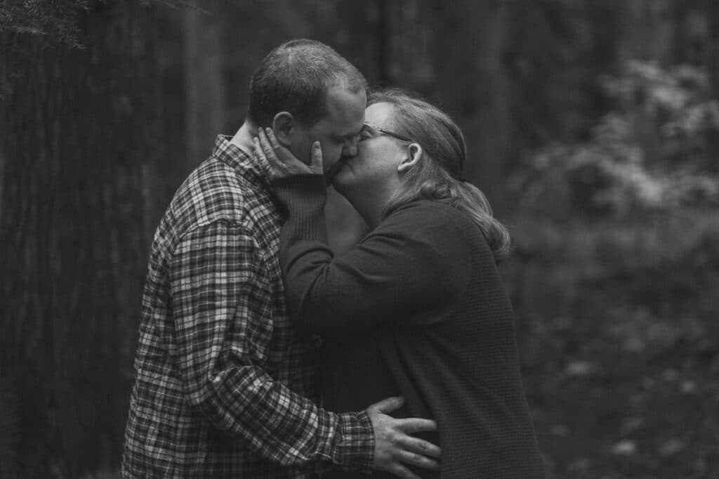 Couple in the forest during their engagement session on the oyster river trail by latitude 49 photography