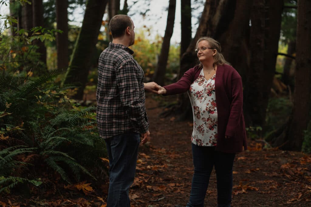 Couple in the forest during their engagement session on the oyster river trail by latitude 49 photography