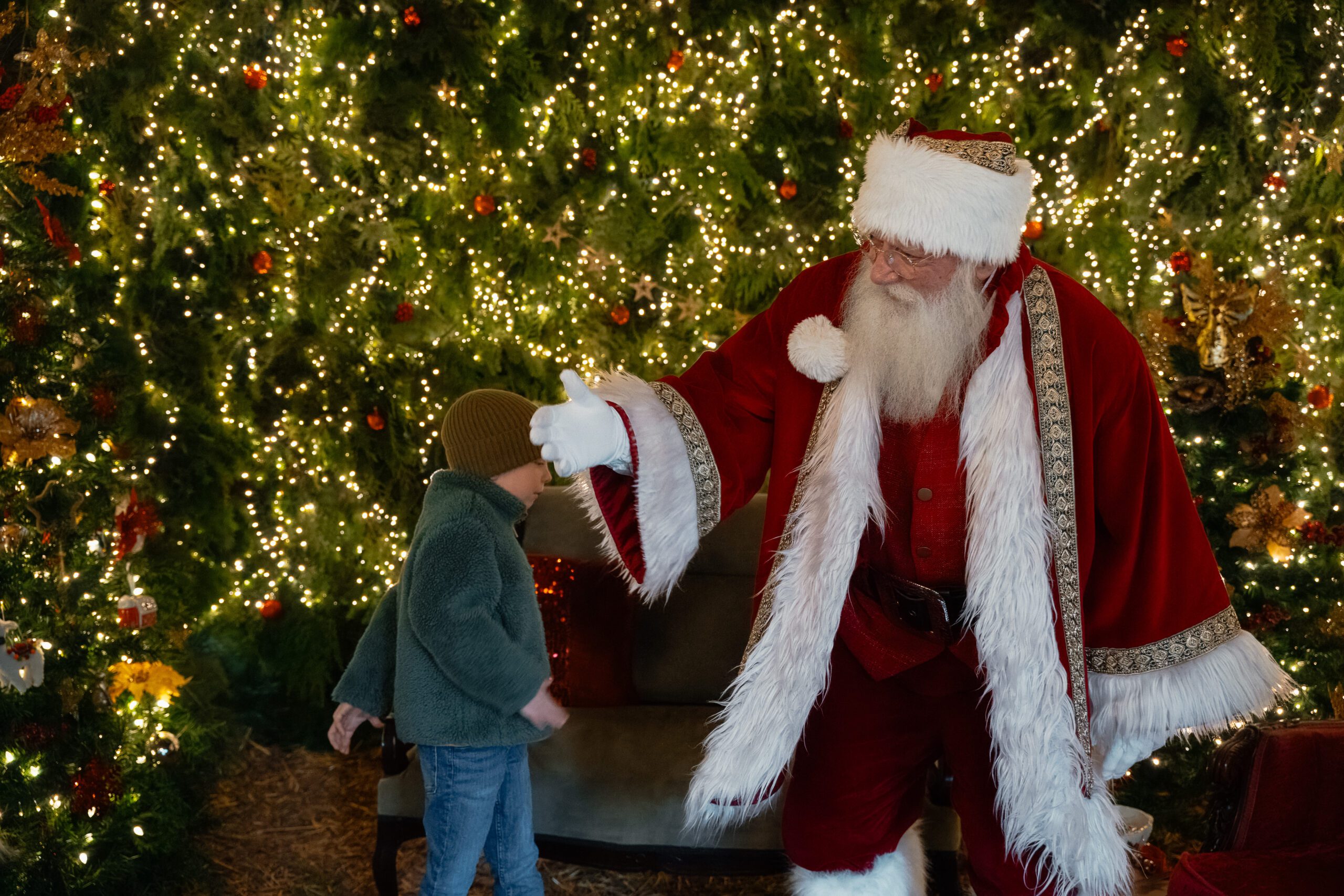 Santa Claus doing the floss dance with one of the kids at Holly Hill Farm in Campbell River