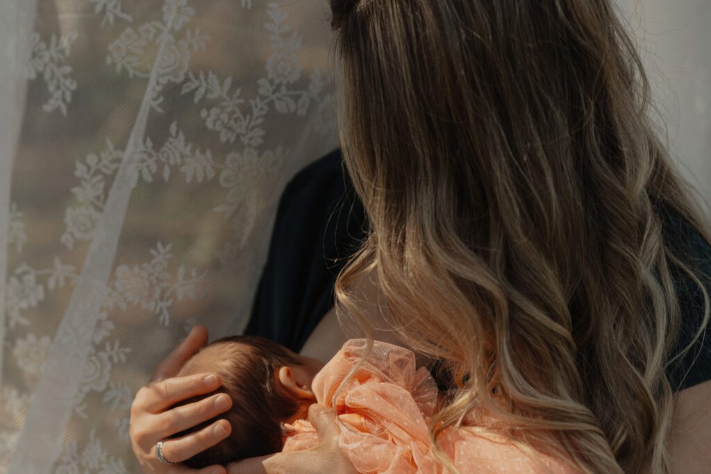 Tender moment between mother and baby captured naturally by Latitude 49 Photography