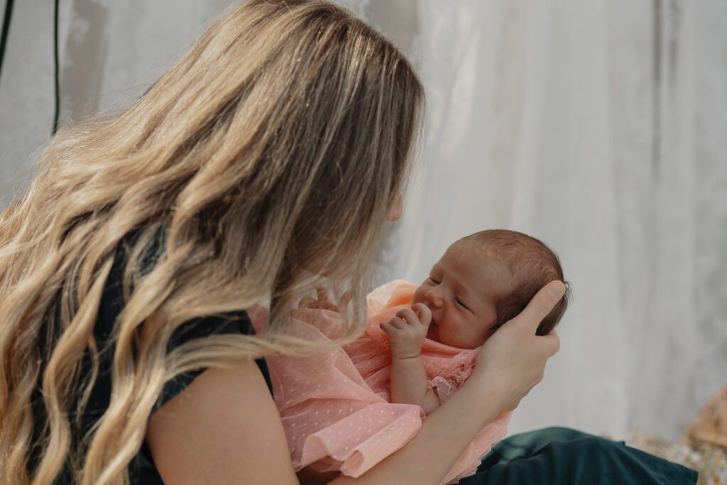Candid Vancouver Island family photography with new mom and baby snuggling outdoors