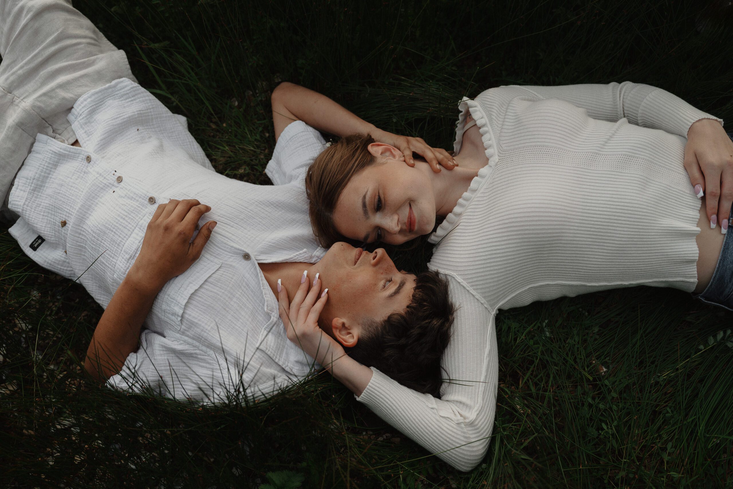 Couple laying in the grass during their couples session near Black Rock Resort in Ucluelet by Latitude 49 photography