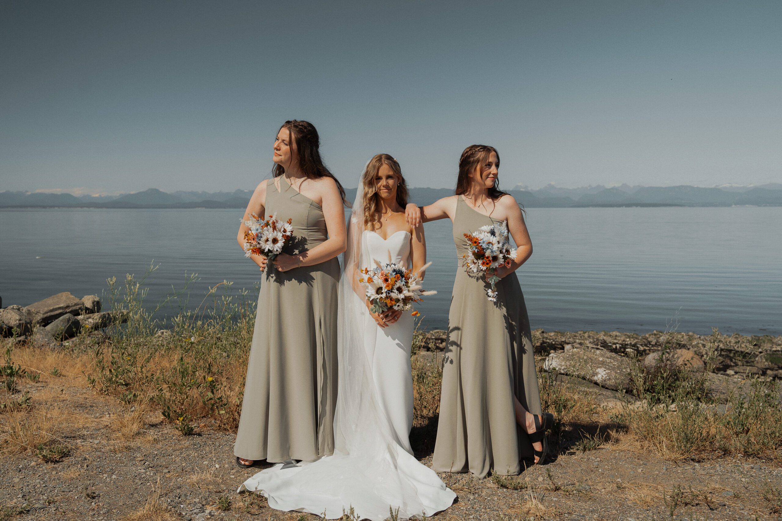 Bride at the beach with her wedding party during wedding portraits in Comox by latitude 49 Photography