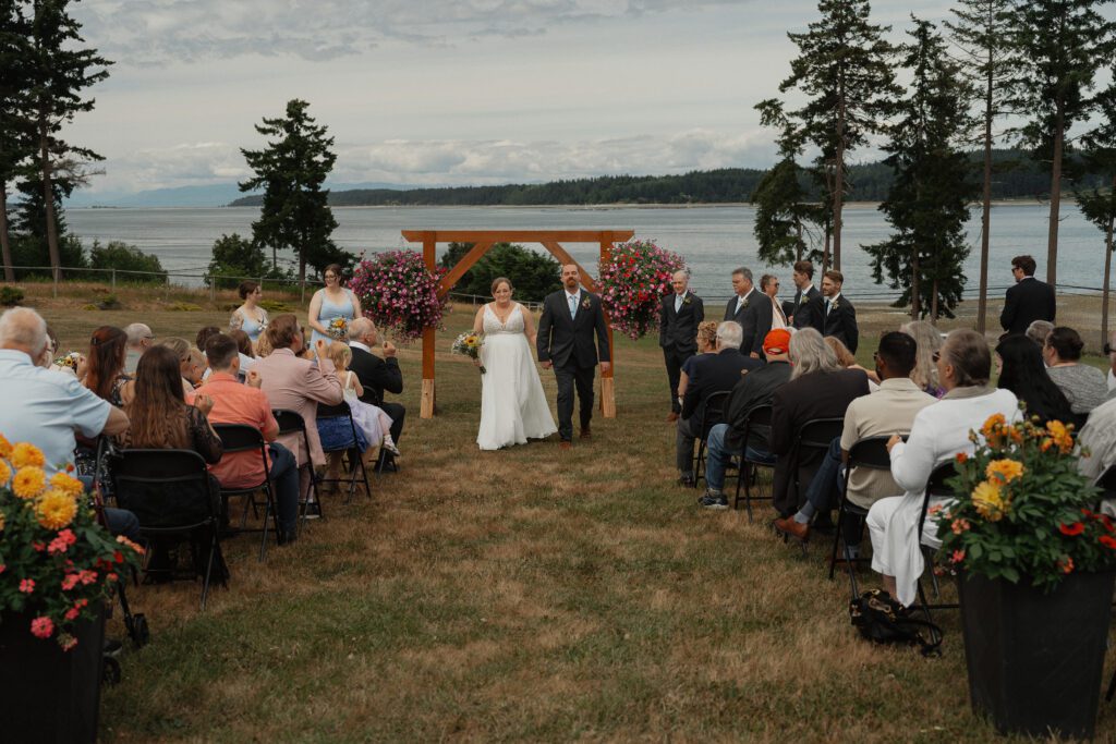 Couple walking back down the aisle during wedding ceremony