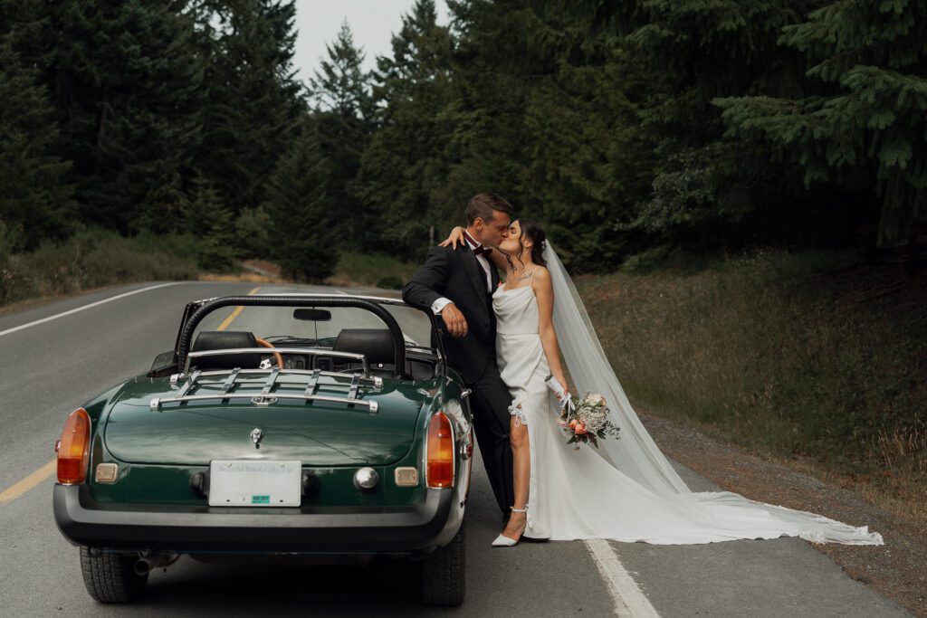 editorial pose of bride and groom leaning against MGB during their wedding portraits in Victoria
