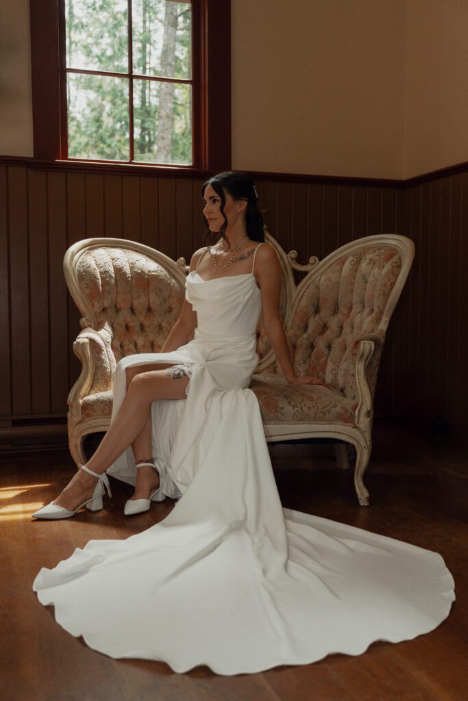 Bride sitting on vintage settee during getting ready portraits at Caleb Pike Heritage Park in Victoria 