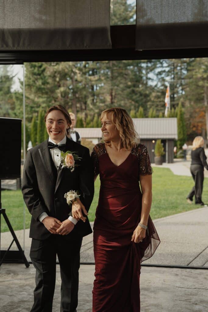 groom and mom walking down the isle
