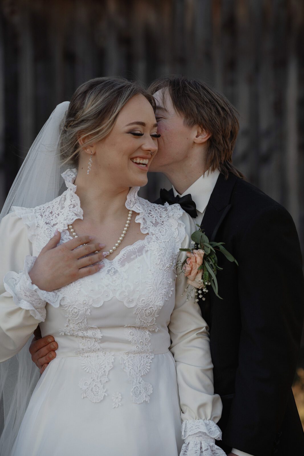 Bride and groom in front of an old barn during their wedding portraits in the Comox Valley by Latitude 49 Photography