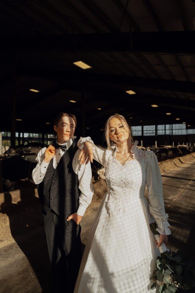 bride and groom with hard lighting in the dairy cow barnd