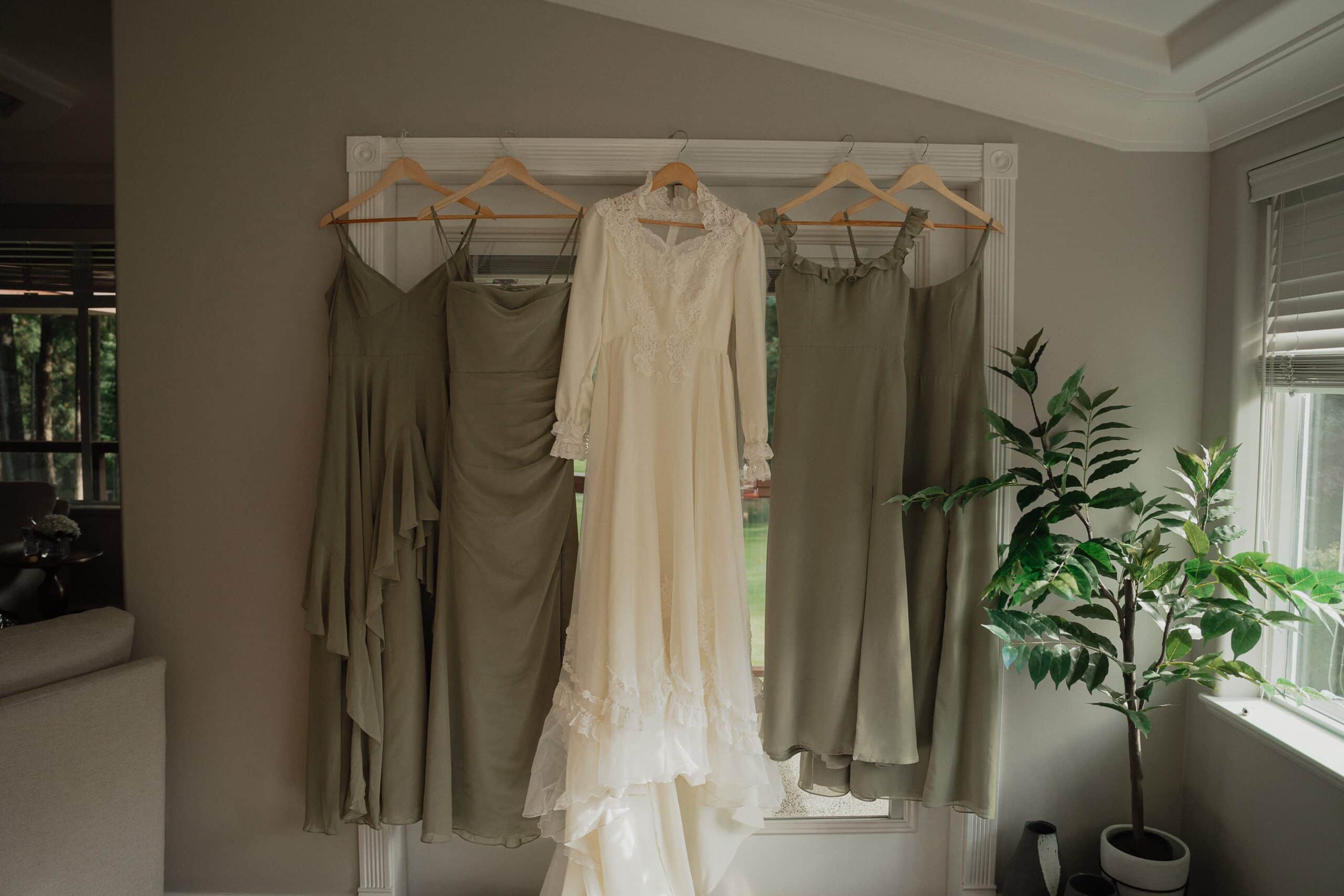 Bride's vintage wedding dress and her bridesmaids dresses during getting ready photos at crown isle by latitude 49 photography