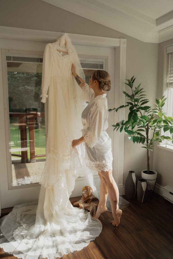 bride examining her wedding dress