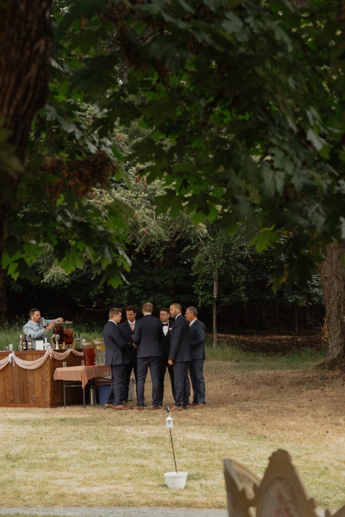 groom and groomsman share a moment of prayer before the wedding ceremony at Caleb Pike Heritage Park in Victoria by Latitude 49 Photography