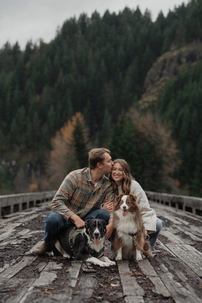 Connor Liz and their dogs for a portrait during their fall engagement session at the Trestle Bridge in Campbell River.