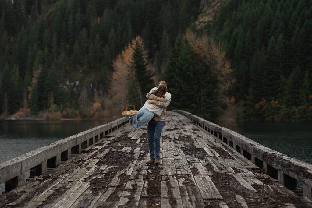 Connor swinging liz around during their fall engagement session at the Trestle Bridge in Campbell River.
