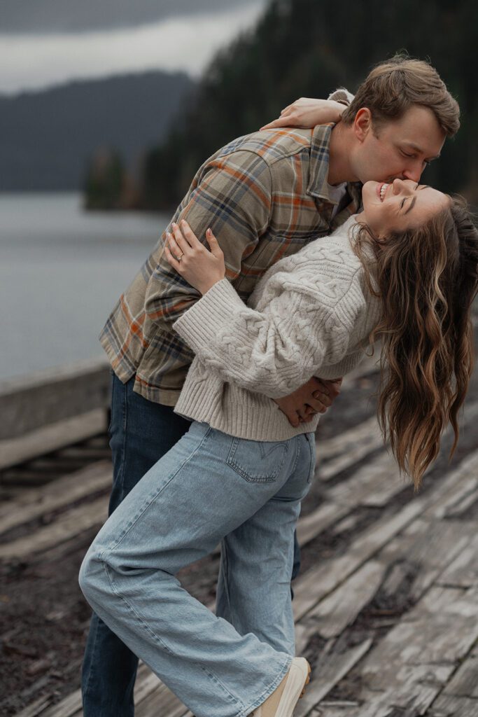 connor attacking liz with kisses during their fall engagement session at the Trestle Bridge in Campbell River.