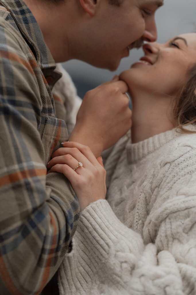 connor and liz touching noses during their fall engagement session at the Trestle Bridge in Campbell River.