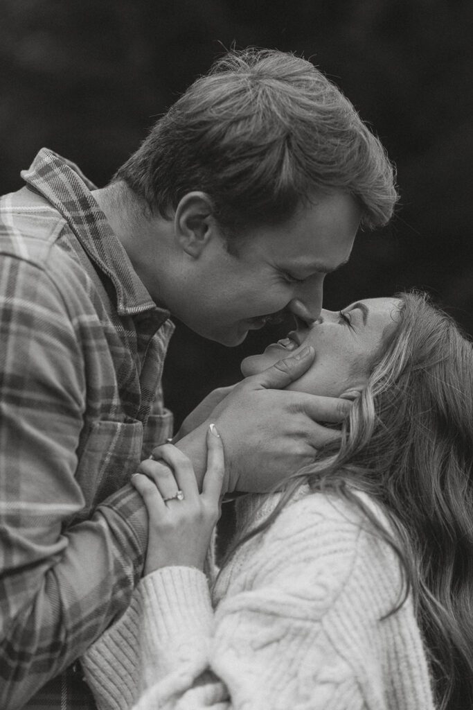 Connor and liz sharing a kiss during their fall engagement session at the Trestle Bridge in Campbell River.