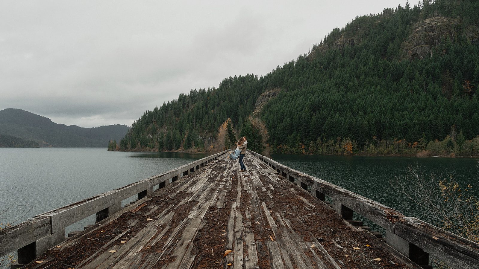 Connor picking Liz up and swinging her around during their fall engagement session at the Trestle Bridge in Campbell River.