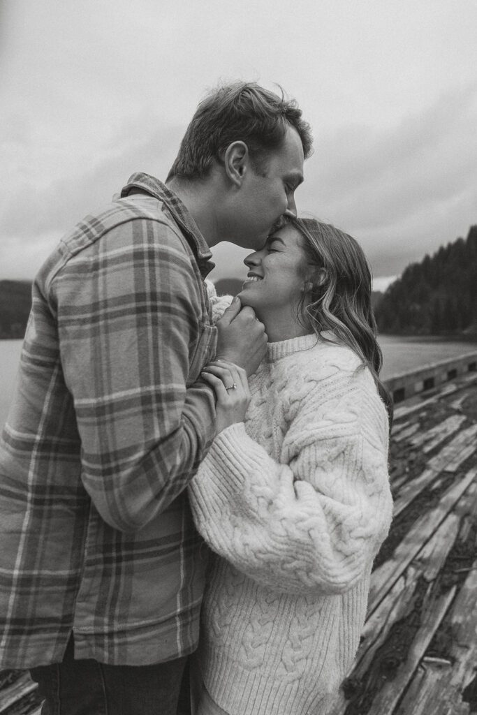 Connor kissing Liz's forehead during their fall engagement session at the Trestle Bridge in Campbell River.