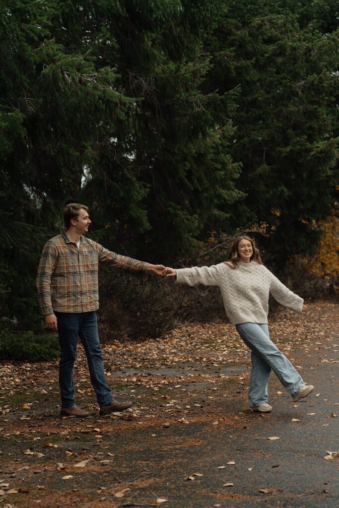 Connor and liz dancing to their first dance song during their fall engagement session at the Trestle Bridge in Campbell River.