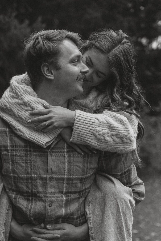 Connor piggybacking liz during their fall engagement session at the Trestle Bridge in Campbell River.