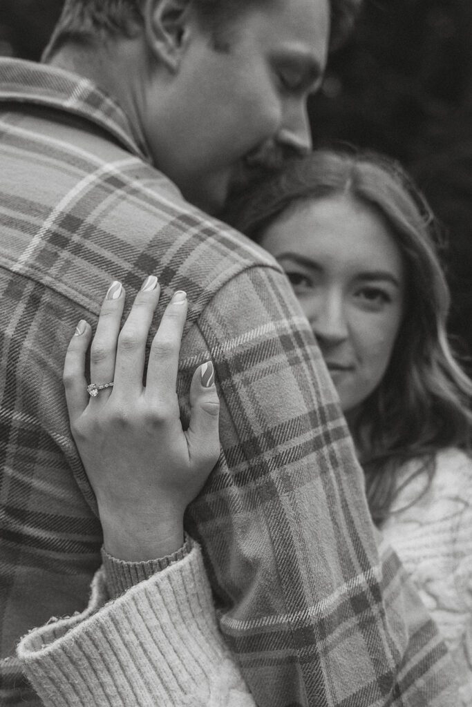 black and white photo of liz's engagement ring during their fall engagement session at the Trestle Bridge in Campbell River.
