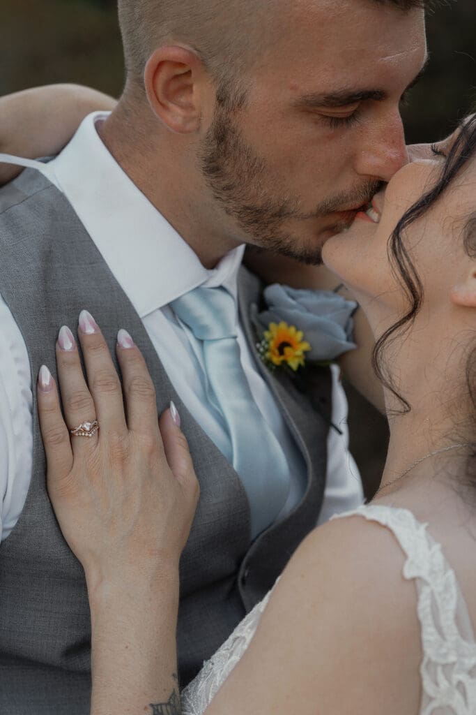 Bride and groom sharing a kiss during wedding portraits