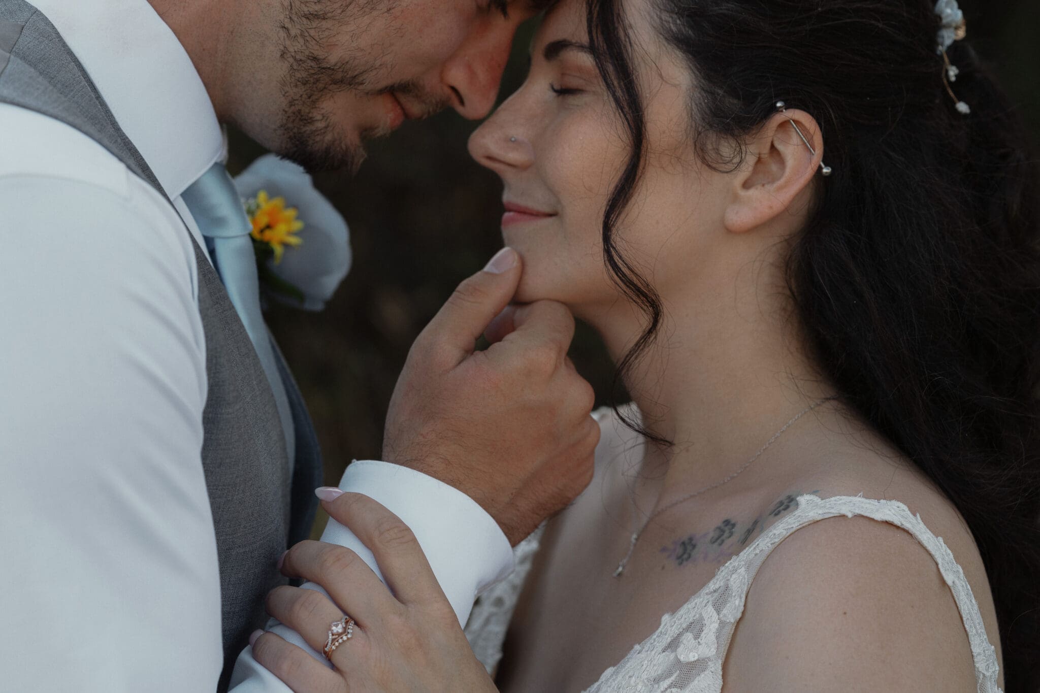 Couple touching foreheads during their wedding portraits at Airforce Beach by latitude 49 photography