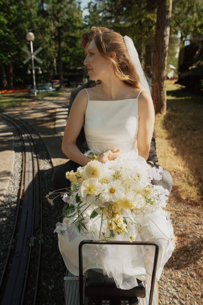Bride and groom on the train ride at heritage acres in Saanichton by latitude 49 photography