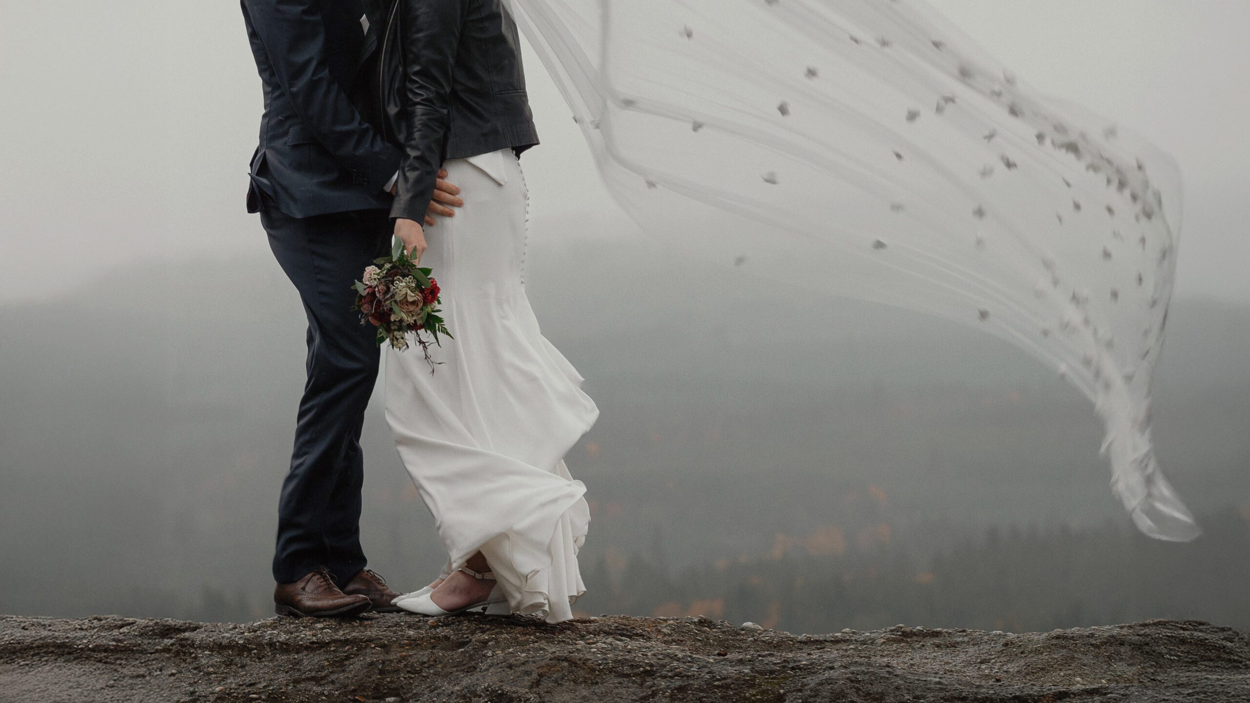 Photo of windswept veil and wedding dress at Little Mountain Lookout by Latitude 49 Photography