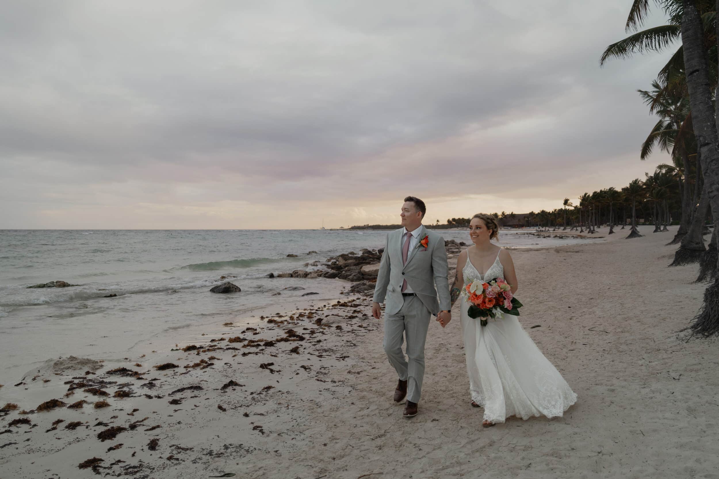 Bride and groom walking on the beach in mexico
