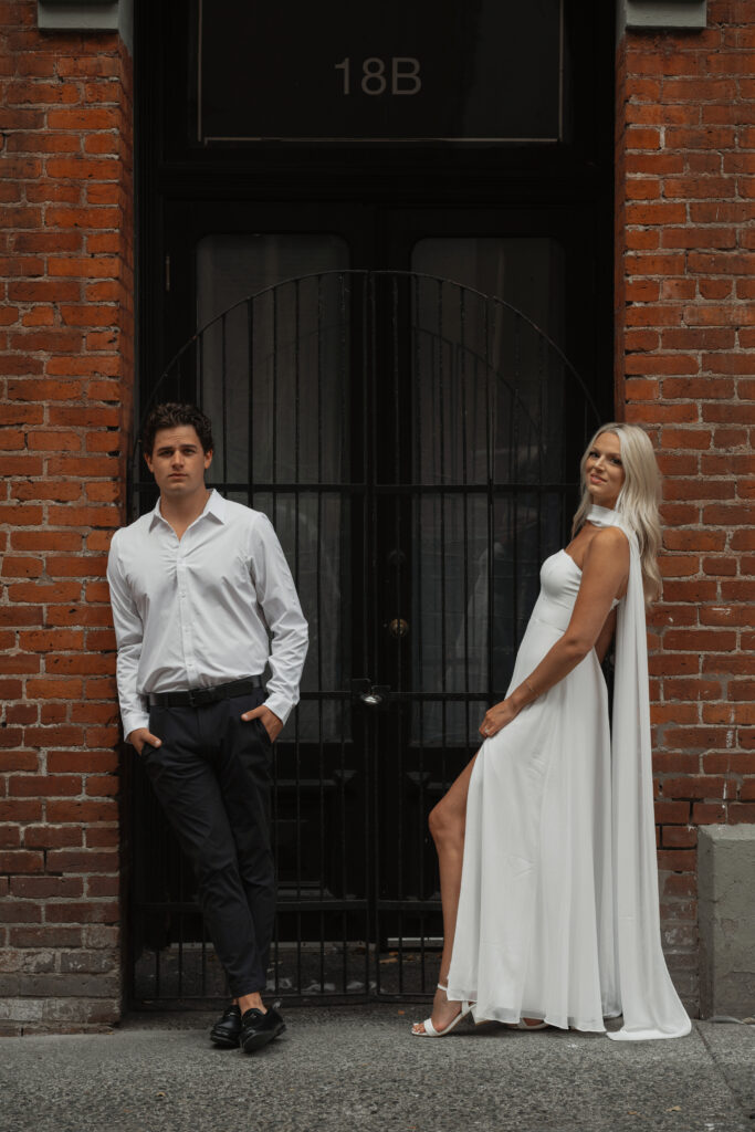 Engaged couple standing in a brick doorway in Victoria