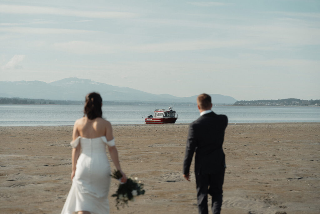 Bride and groom walking to their kingfisher boat