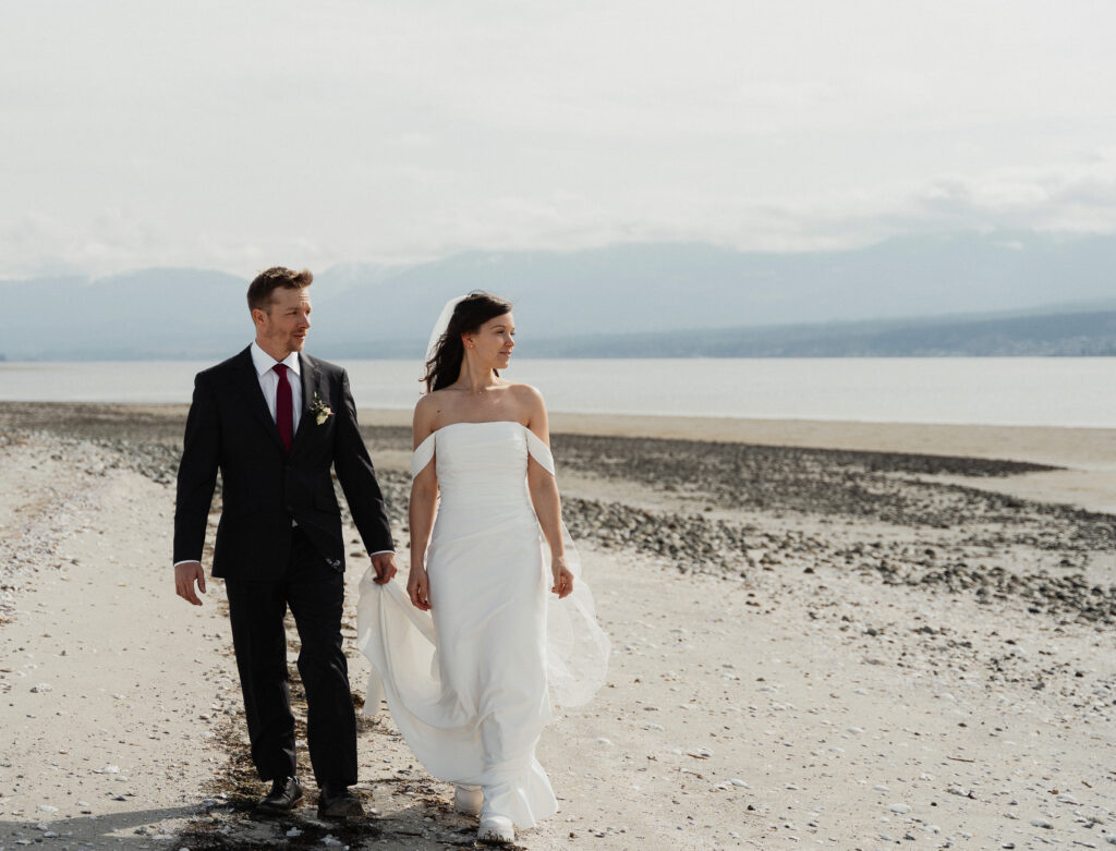 Bride and groom walking on the beach